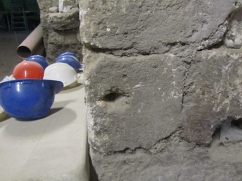 Holes in the pillars to tie the animals in the stable